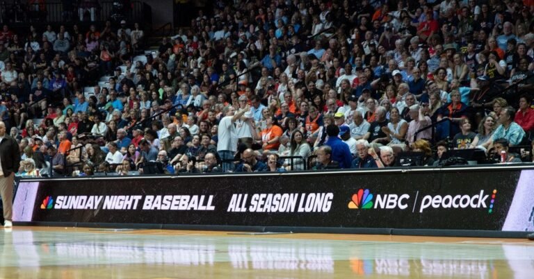 NBC Sunday Night Baseball promotion on a courtside advertising board.