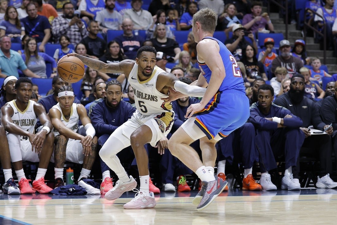 Dejounte Murray dribbles against Oklahoma City during a Pelicans preseason game.