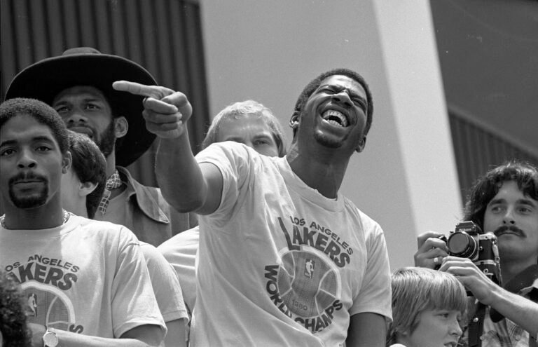Magic Johnson laughs with Lakers teammates during a championship rally in 1980.