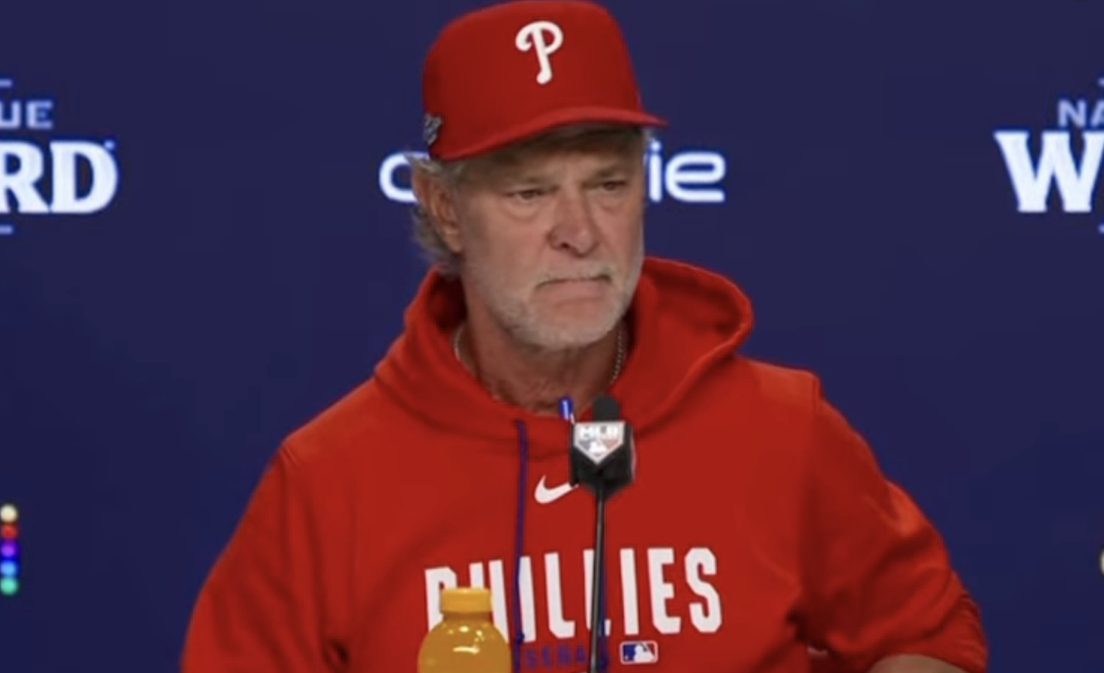 Don Mattingly in a Phillies cap and red hoodie at his postgame news conference.
