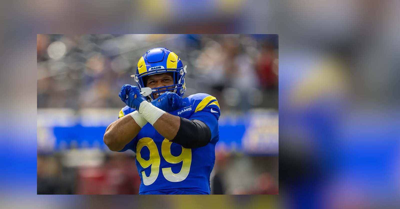 Aaron Donald in a blue and yellow Los Angeles Rams number 99 uniform.