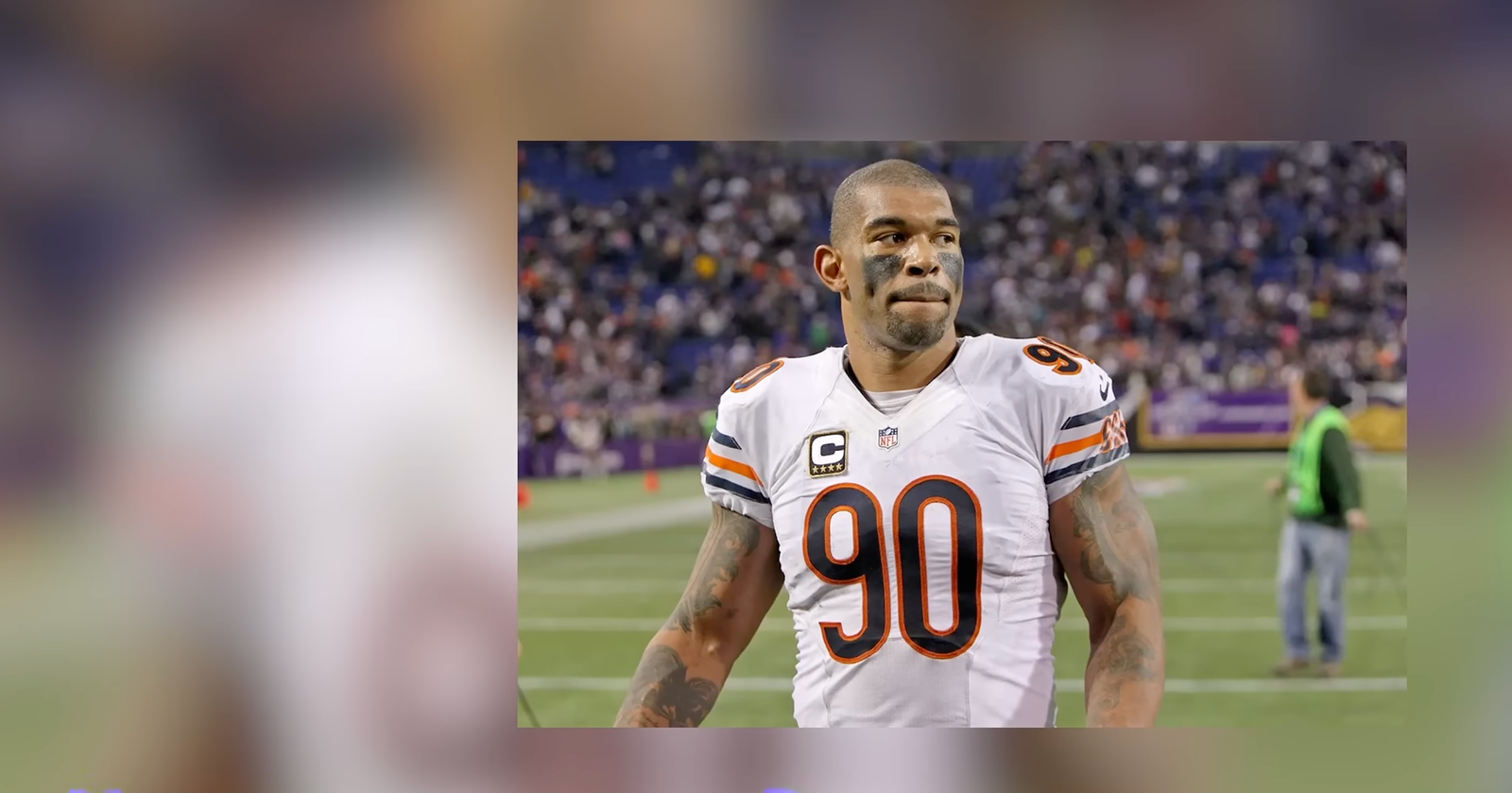 Julius Peppers in a white Chicago Bears number 90 uniform.