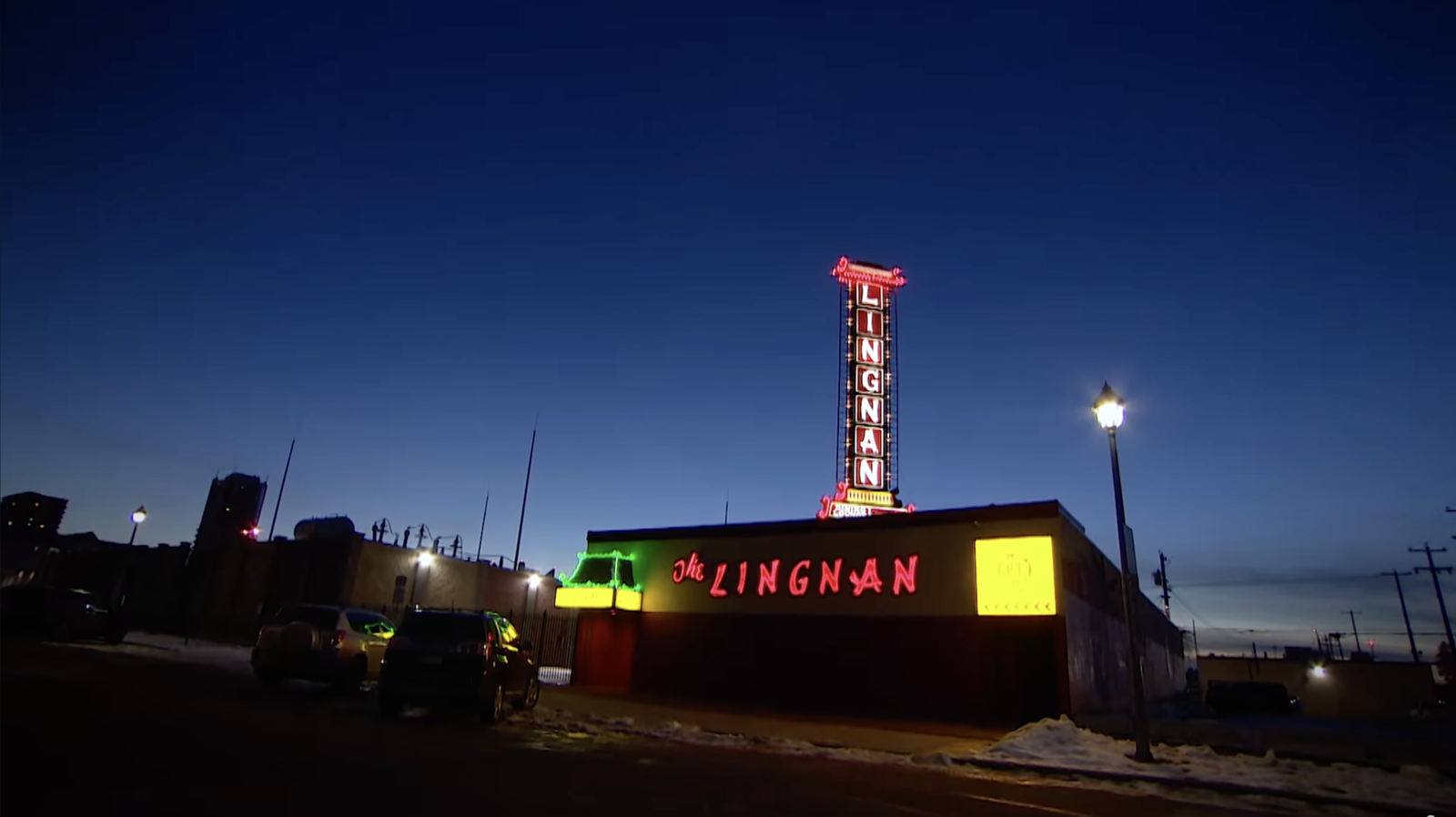 The Lingnan restaurant exterior at dusk with its red neon signs illuminated