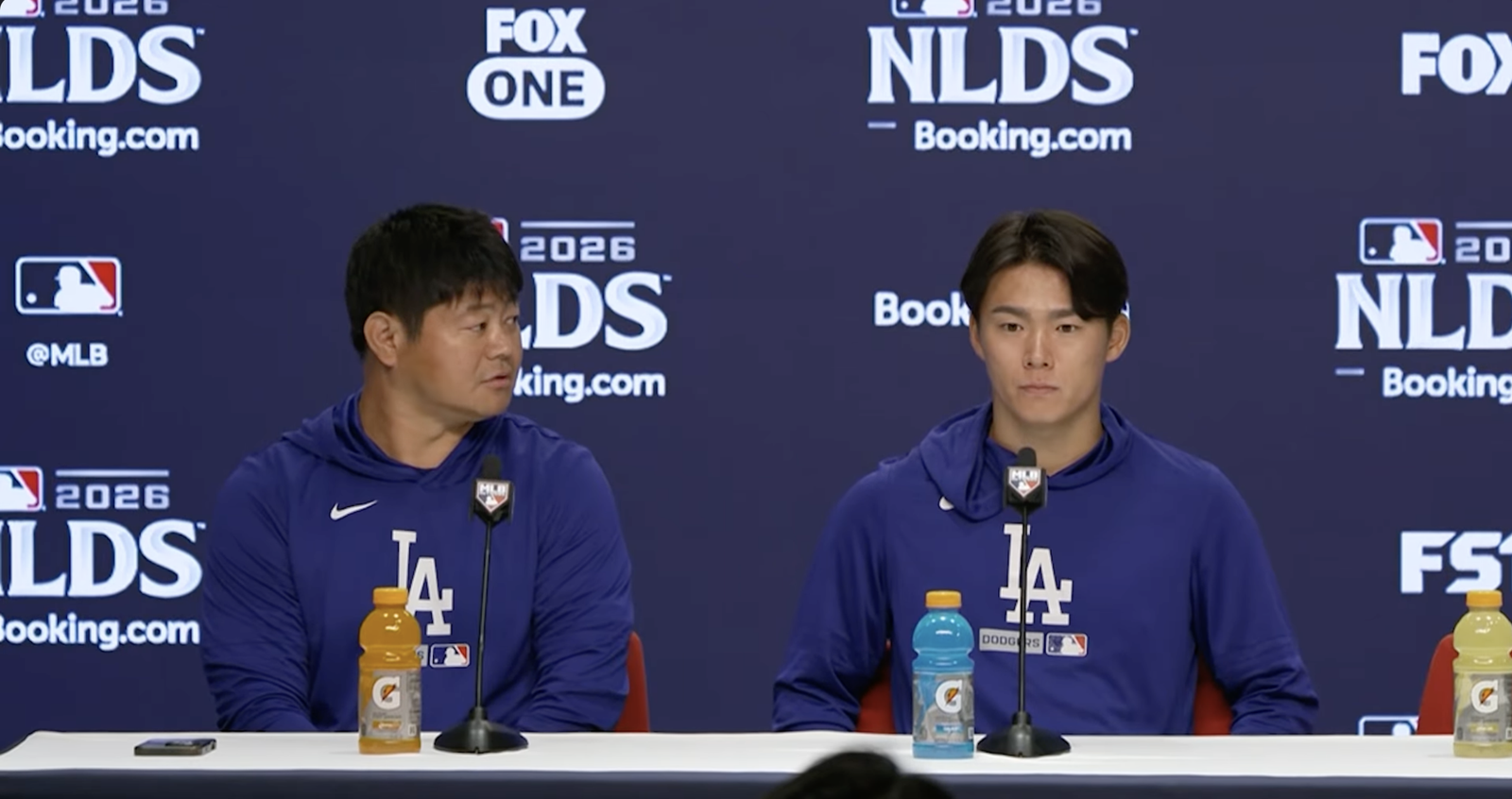 Yoshinobu Yamamoto, right, sits beside his interpreter at a Dodgers NLDS press conference