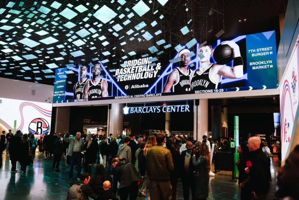 Fans enter Barclays Center beneath Alibaba and Nets branding.