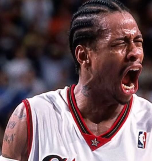 Allen Iverson in a white Philadelphia 76ers jersey.