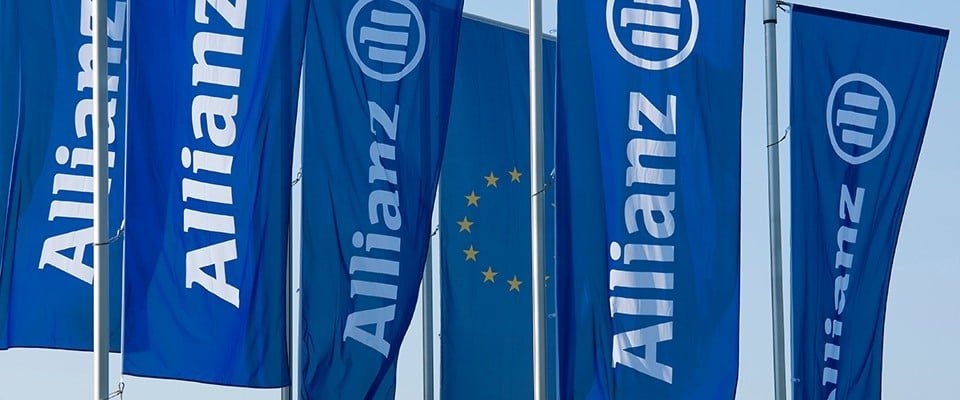 Blue Allianz flags flying outside a company building.