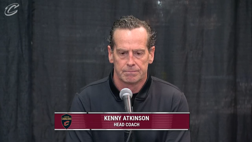 Kenny Atkinson speaks at a microphone.