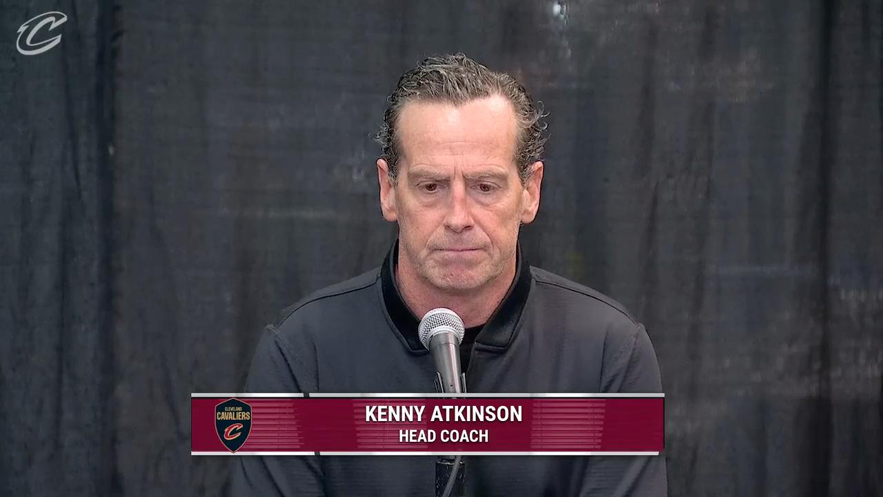 Kenny Atkinson speaks at a microphone.