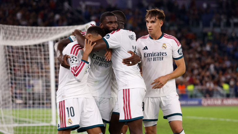 Real Madrid players celebrate during the Champions League match at Roma.