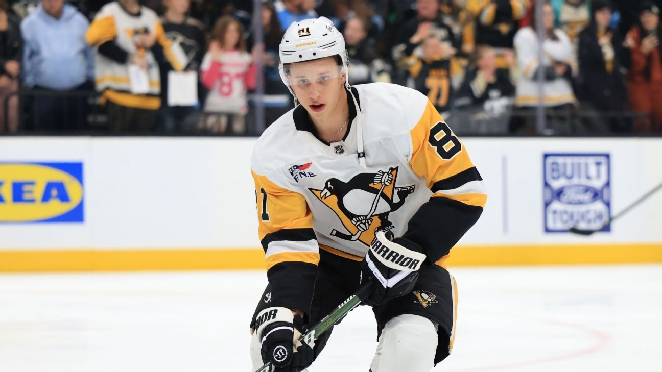 Ben Kindel warms up on the ice in a white Pittsburgh Penguins uniform.