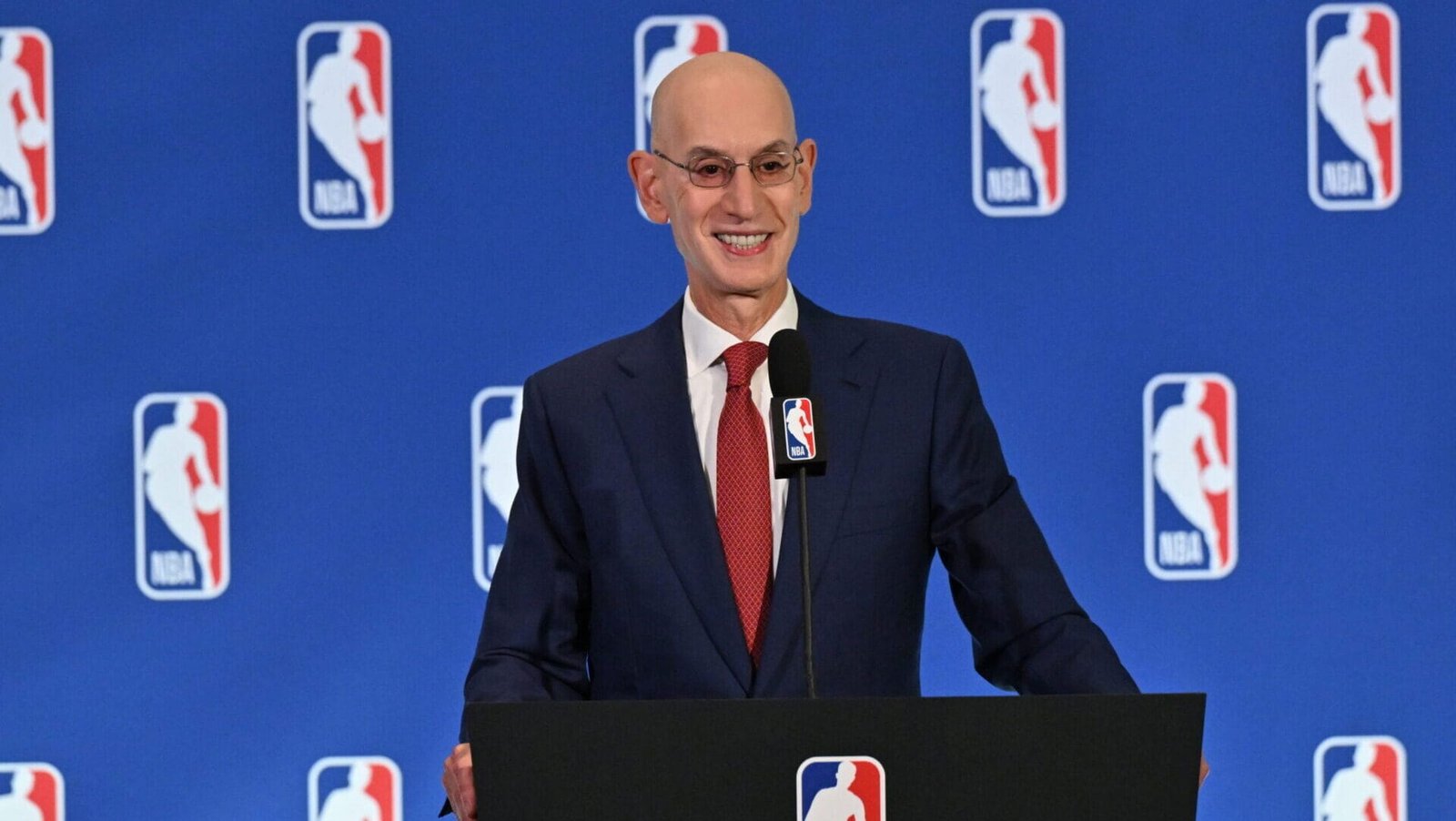 NBA Commissioner Adam Silver speaks at a podium.