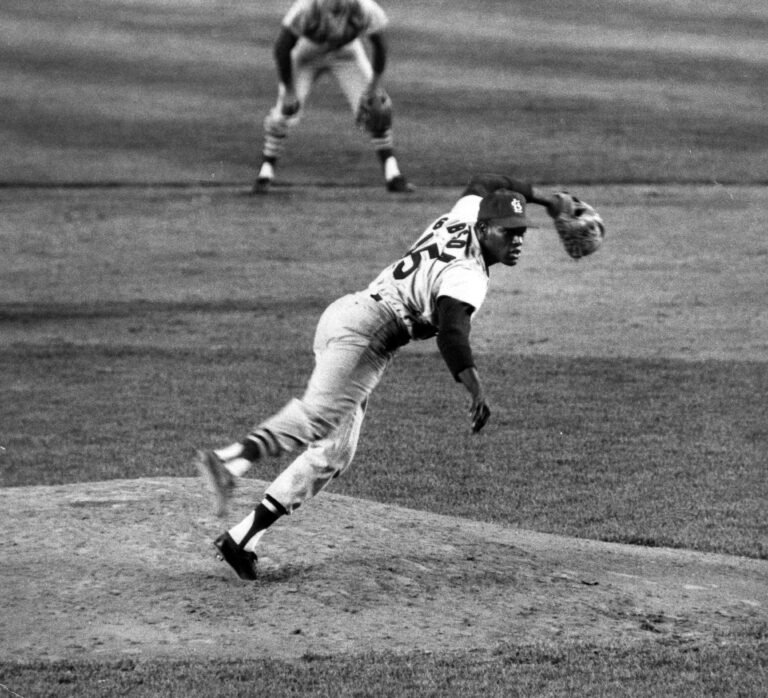 Bob Gibson delivers a pitch in an archival photograph. The image is not presented as being from Game 1 of the 1968 World Series.