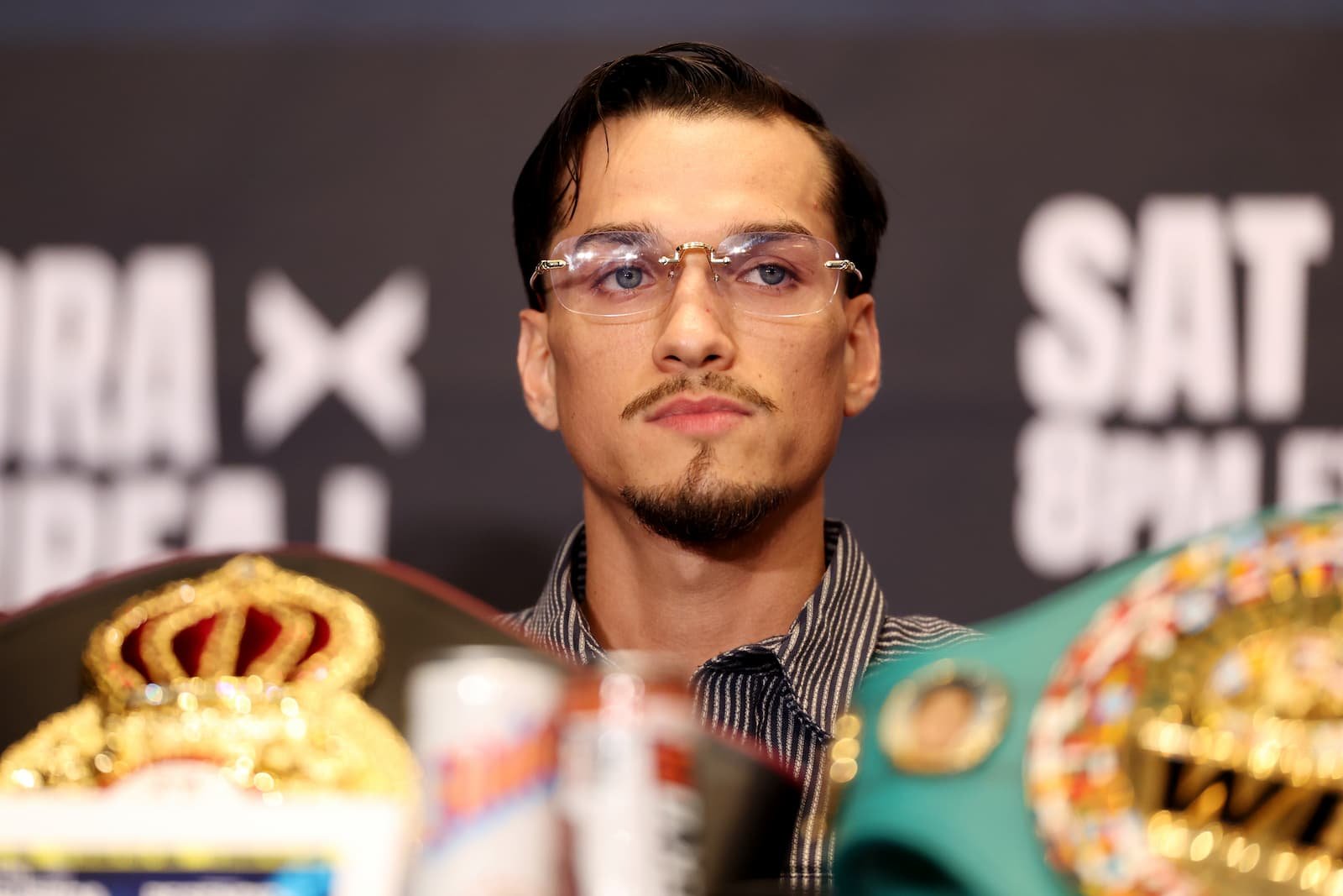 Brandon Figueroa sits behind championship belts at the October 15 press conference in Las Vegas.