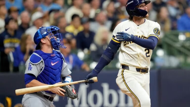 Brice Turang watches his fourth-inning home run as Dodgers catcher Will Smith looks up during NLCS Game 1 on October 11, 2026.