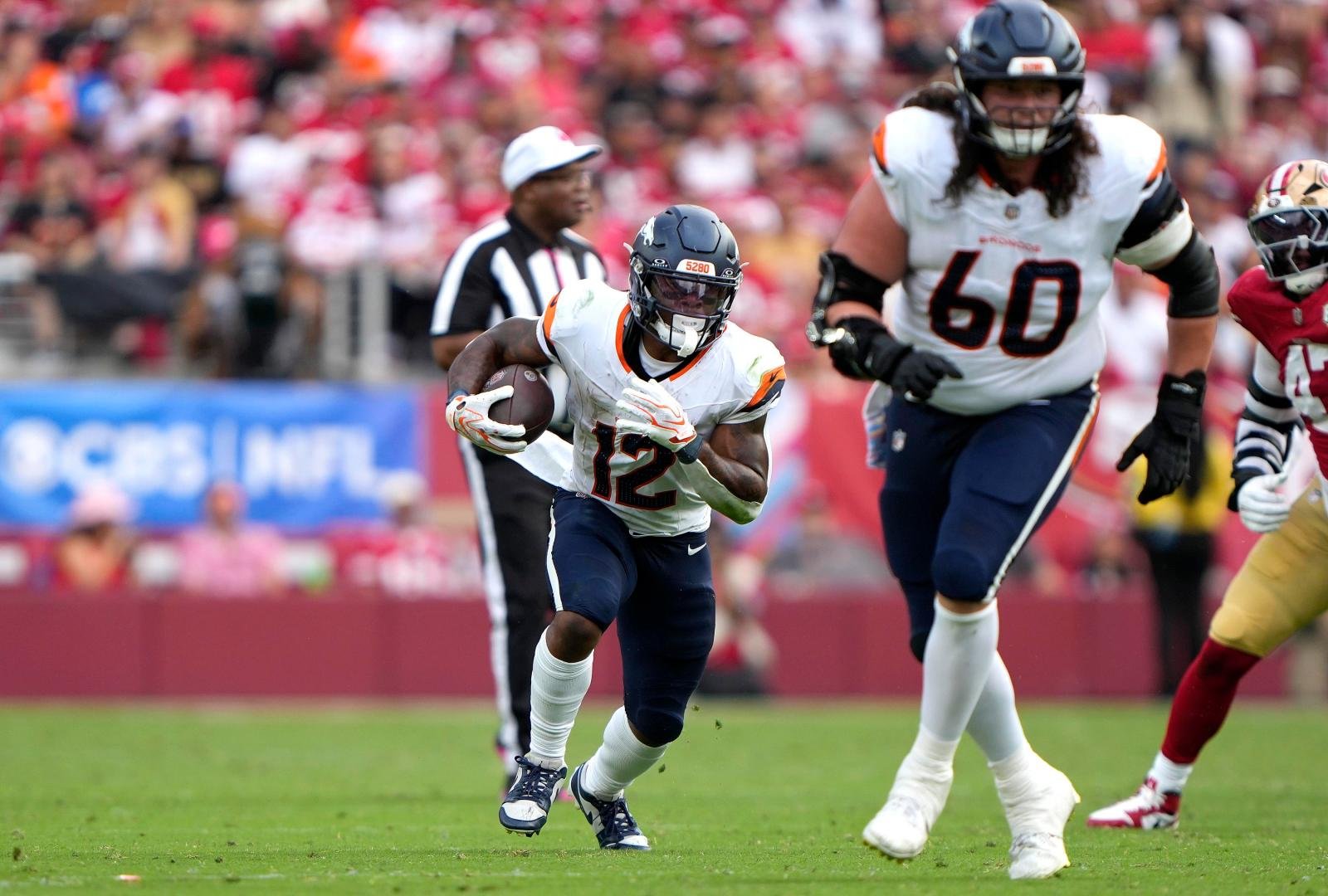 A Denver Broncos player runs with the football in a file photograph.