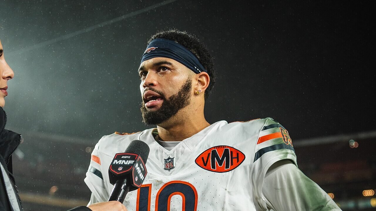 Caleb Williams in a Chicago Bears number 18 jersey speaking into an ESPN microphone.