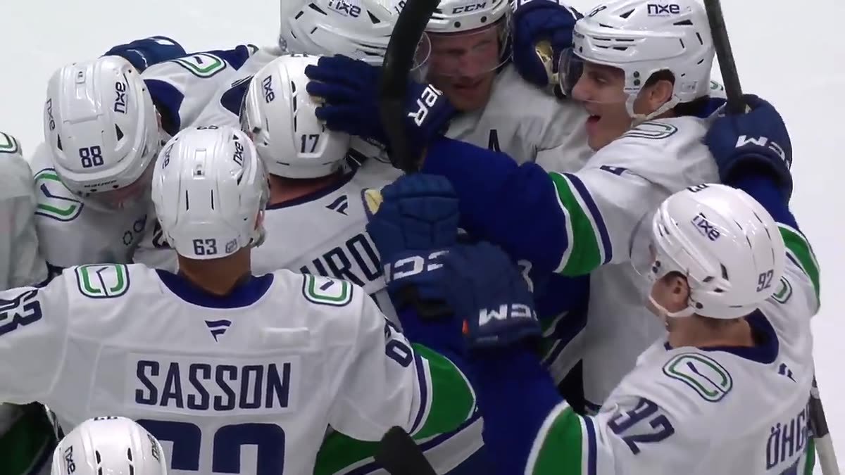 Vancouver Canucks players gather in celebration after their overtime victory against Anaheim.