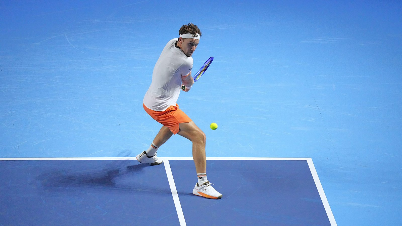 Casper Ruud plays a shot on an indoor blue tennis court in Basel on October 22, 2025.