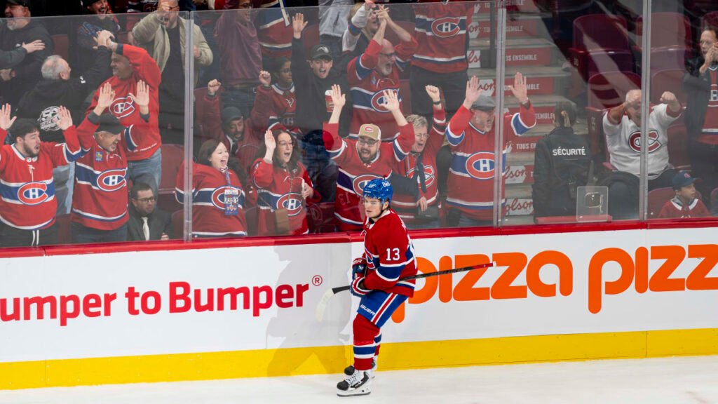 Cole Caufield in Montreal’s red No. 13 sweater beside cheering fans at Centre Bell on October 17, 2026.