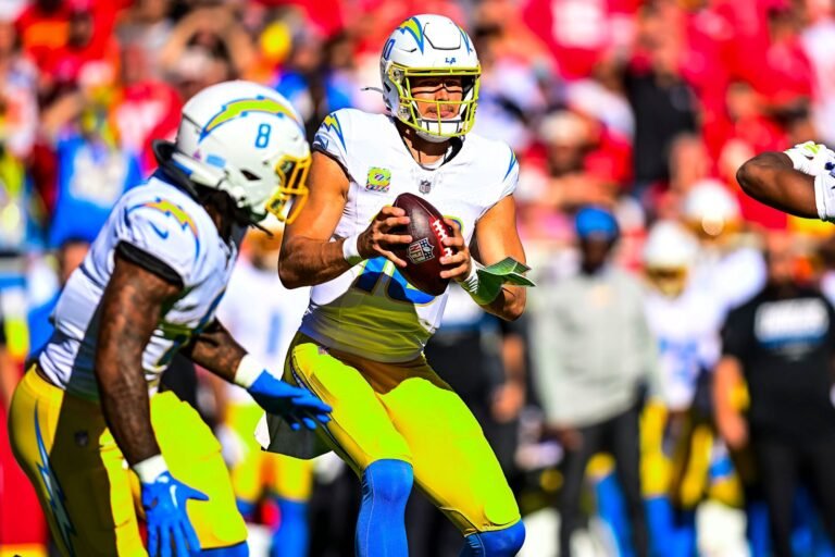 Justin Herbert holds the football behind the Chargers&rsquo; offensive line against Kansas City.