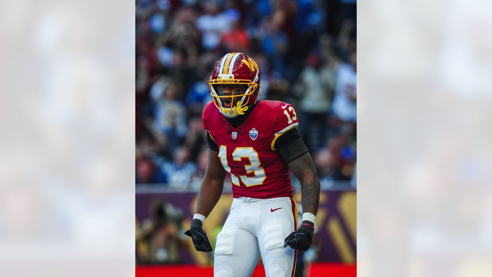 Washington player in a burgundy number 13 uniform on the field in London