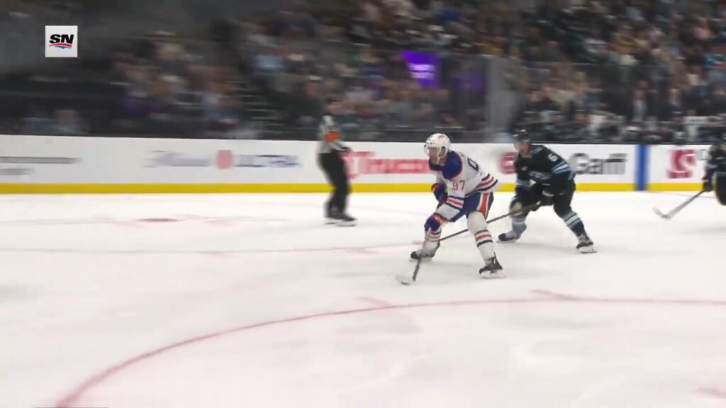 Connor McDavid carries the puck ahead of John Marino before his second goal against Utah on October 17, 2026.