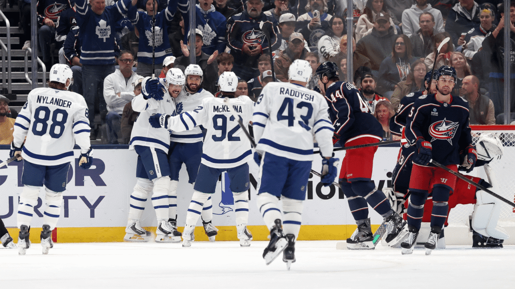 Maple Leafs players celebrate together near the boards during their game in Columbus.