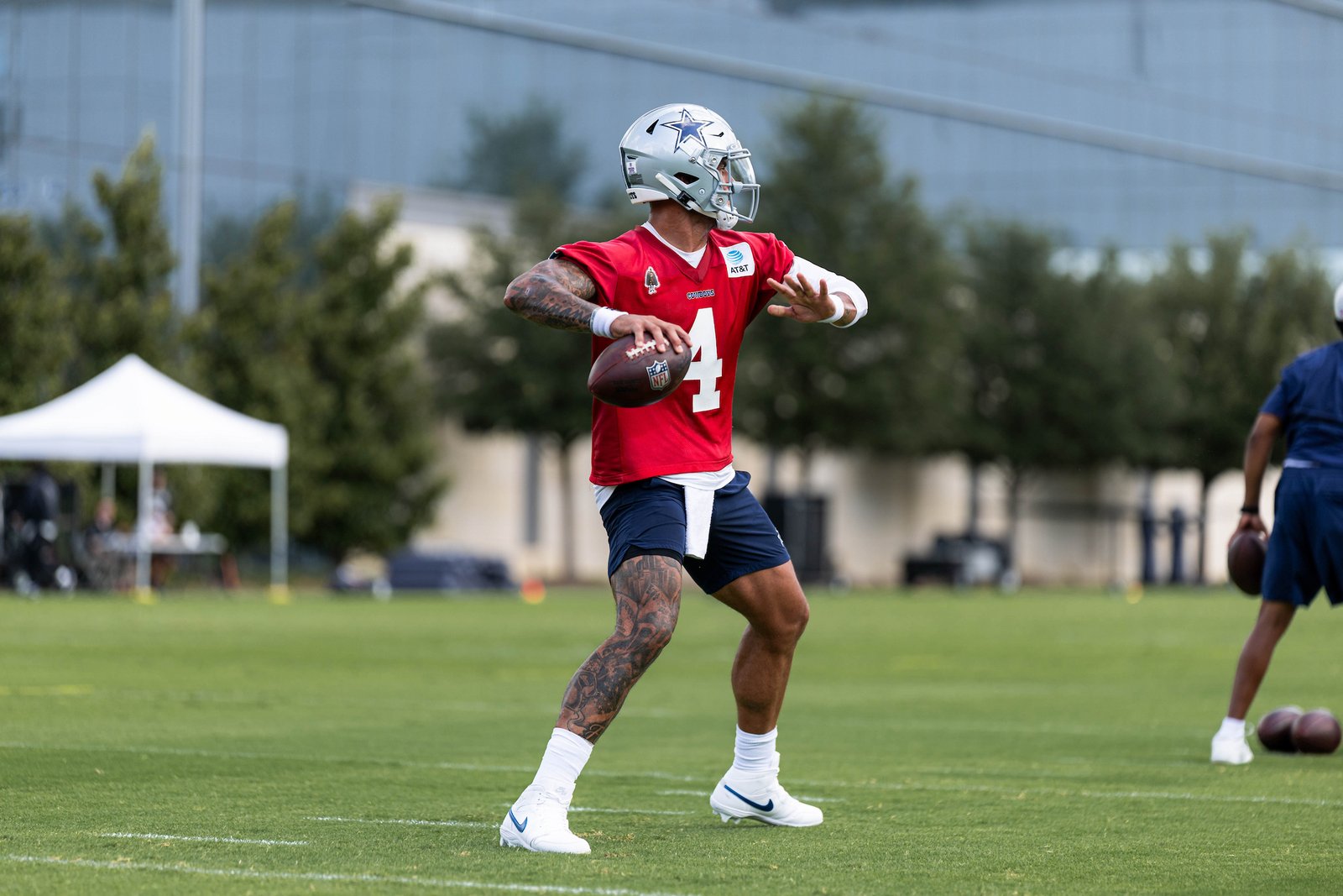 Dak Prescott throws a football at Cowboys practice on October 14, 2026.