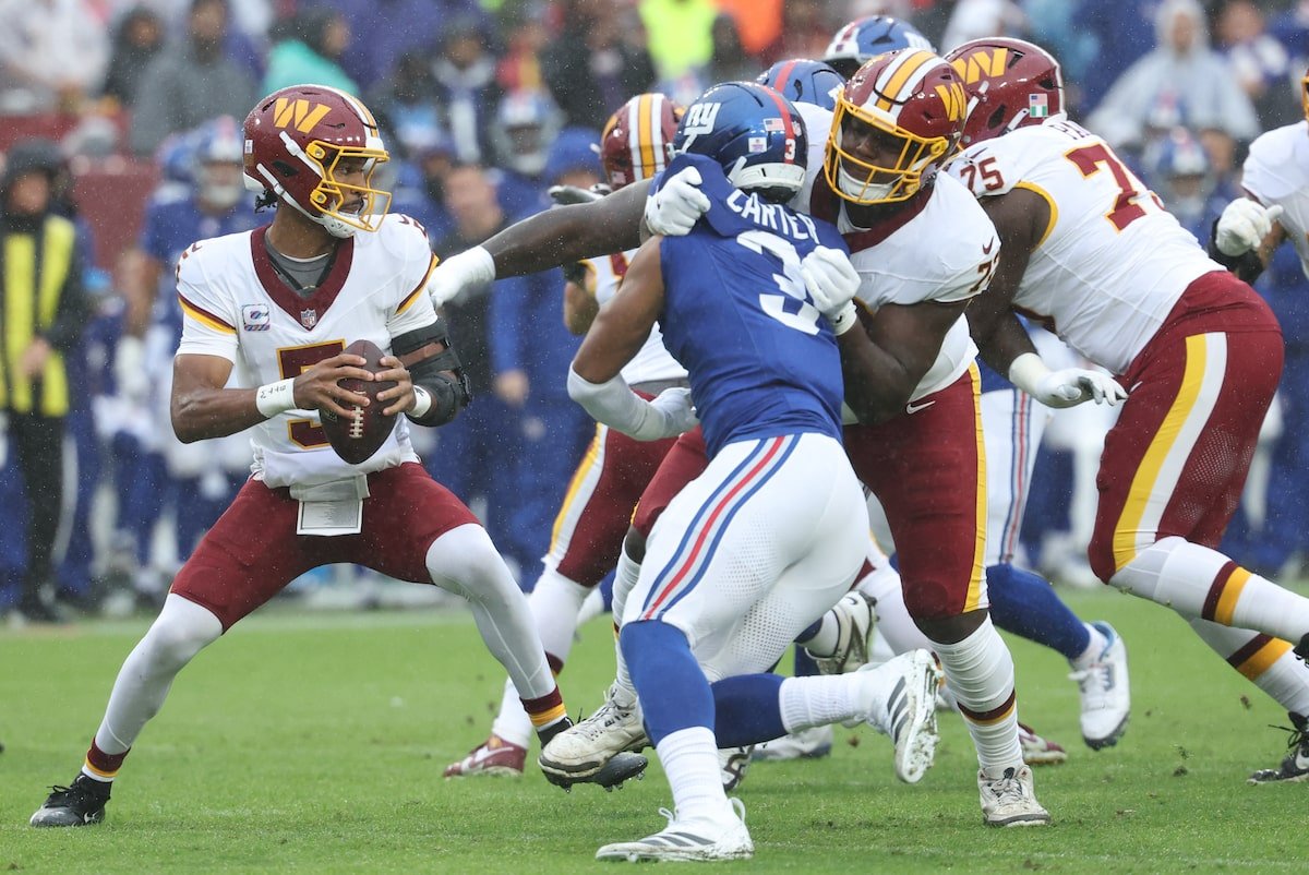 Jayden Daniels looks to pass in a Washington Commanders uniform against the New York Giants at Northwest Stadium on October 11, 2026.