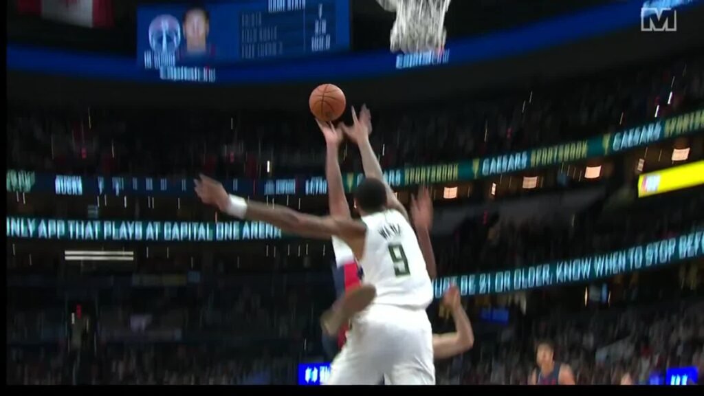 Anthony Davis attacks the basket as Milwaukee defender number 9 contests his shot in Washington.