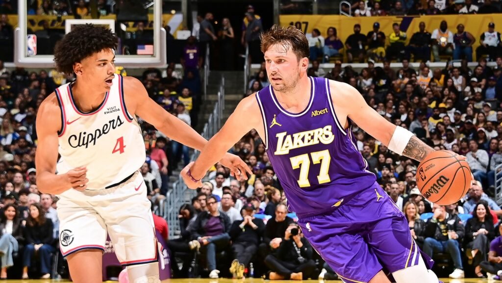 Luka Dončić dribbles for the Lakers against Clippers defender Kobe Sanders.