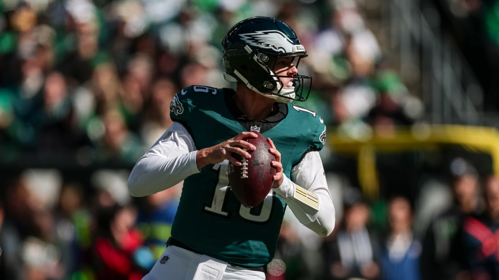 Tanner McKee holds the football in his Eagles uniform.