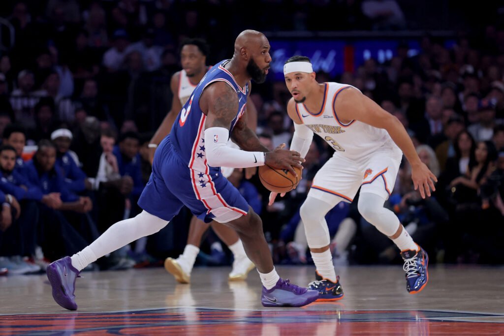 LeBron James looks to pass against Josh Hart during Philadelphia’s season opener at Madison Square Garden on October 20, 2026.