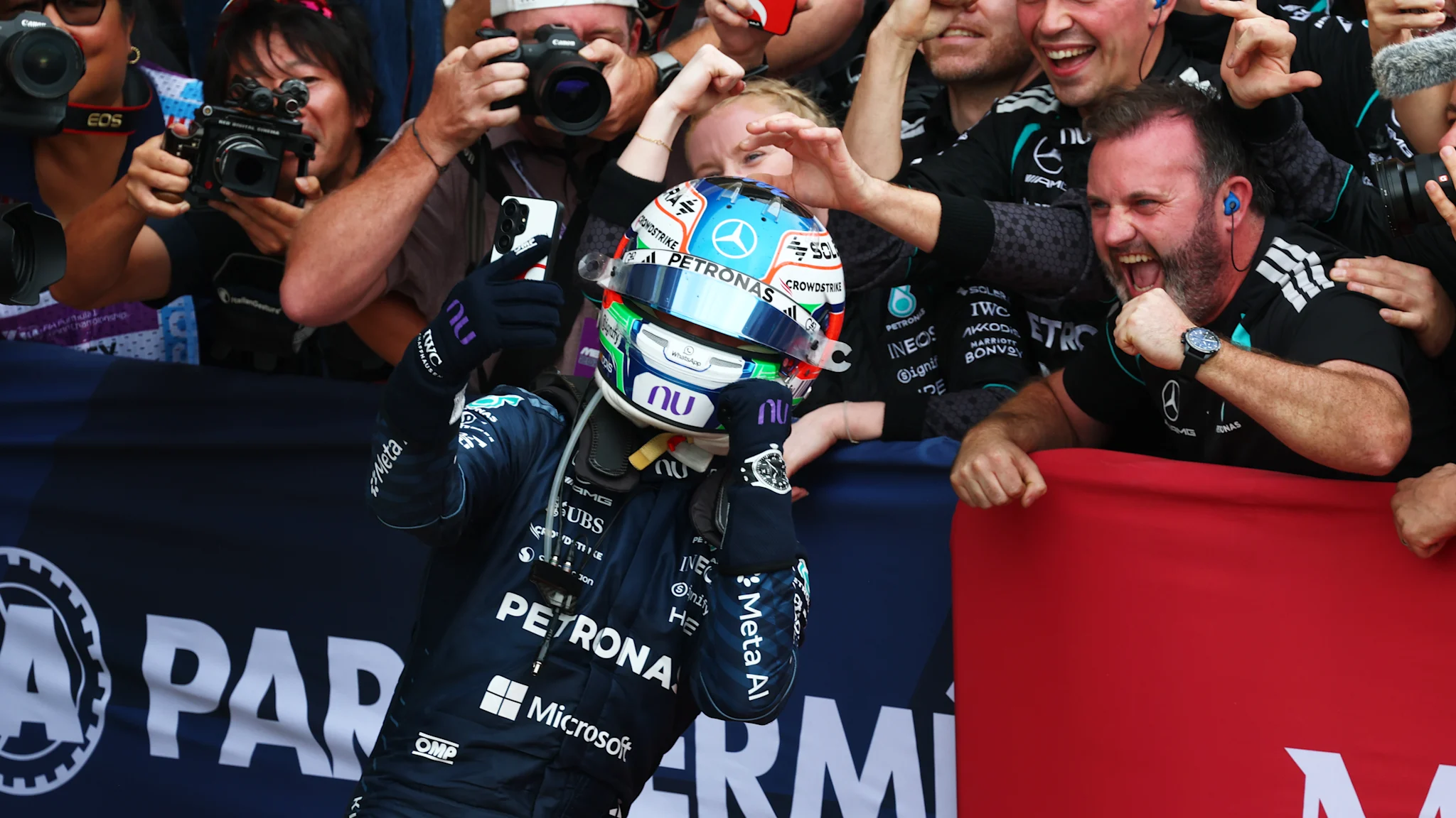 Kimi Antonelli celebrating with Mercedes team members after winning the United States Grand Prix.
