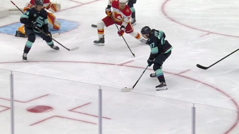 Berkly Catton plays the puck against Calgary during the October 4 Flames–Kraken game.