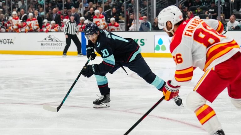 Calgary and Seattle players compete for the puck during their October 4, 2026 game.
