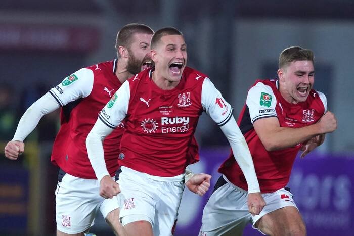 Fleetwood players celebrate after eliminating Arsenal in the Carabao Cup.