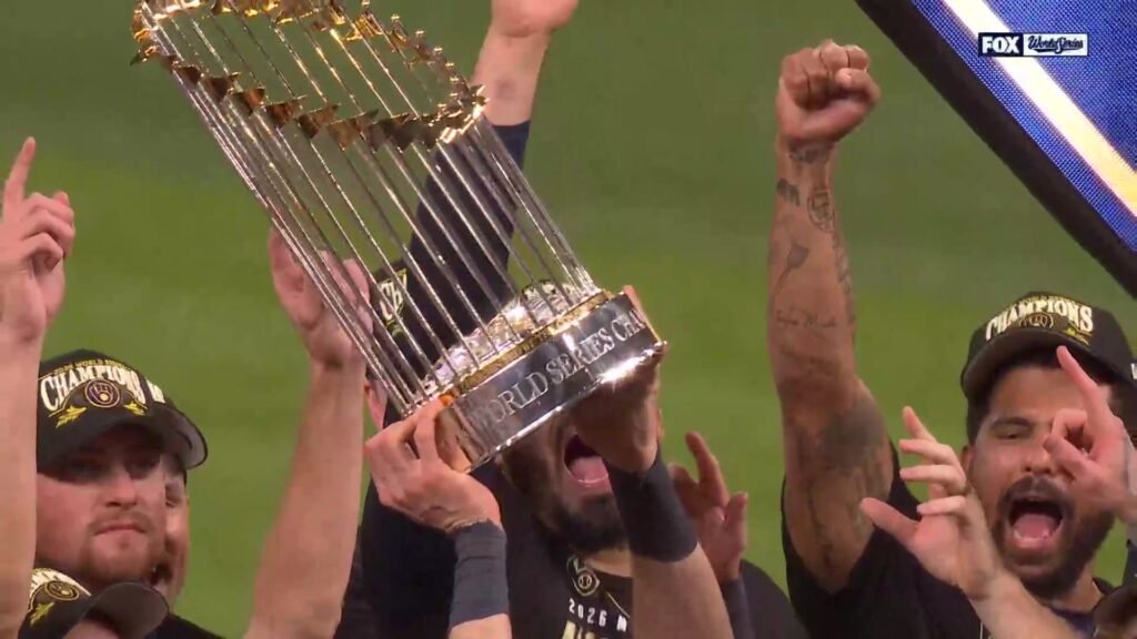 Brewers players hold the World Series trophy overhead during their championship celebration.