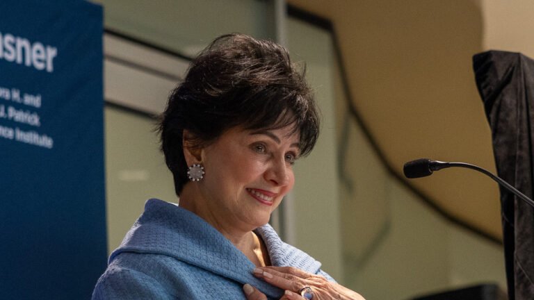 Gayle Benson in a blue jacket speaks at Ochsner Health&rsquo;s neuroscience institute ribbon cutting on October 1, 2026.