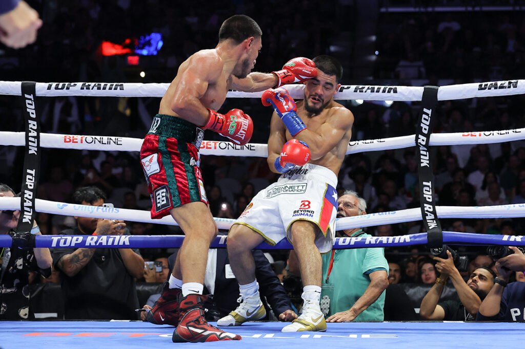 Albert Gonzalez, left, punches Edward Vazquez during their October 24 featherweight fight in San Antonio.