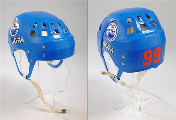 Two views of Gretzky’s classic blue Oilers Jofa helmet, showing its orange 99 and open ear cutouts.