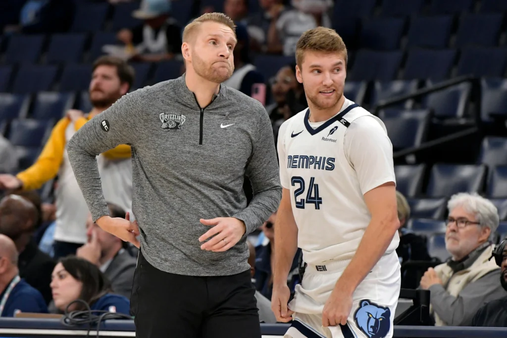 Grizzlies coach Tuomas Iisalo and Cam Spencer stand together during the October 16 preseason game.
