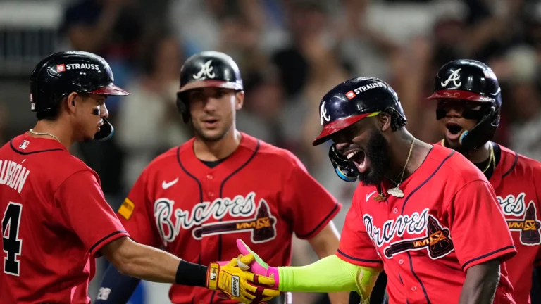 Michael Harris II celebrates his first-inning three-run homer with Matt Olson, Mauricio Dubón and Ronald Acuña Jr. in Game 3.