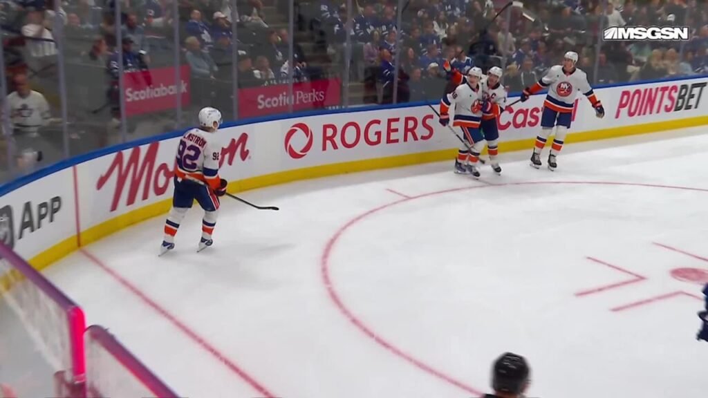 Simon Holmstrom skates toward celebrating Islanders teammates after his third-period goal against Toronto.