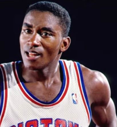 Isiah Thomas in a white Detroit Pistons jersey.