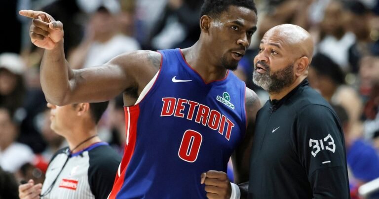Jalen Duren speaks with Detroit Pistons coach J.B. Bickerstaff.