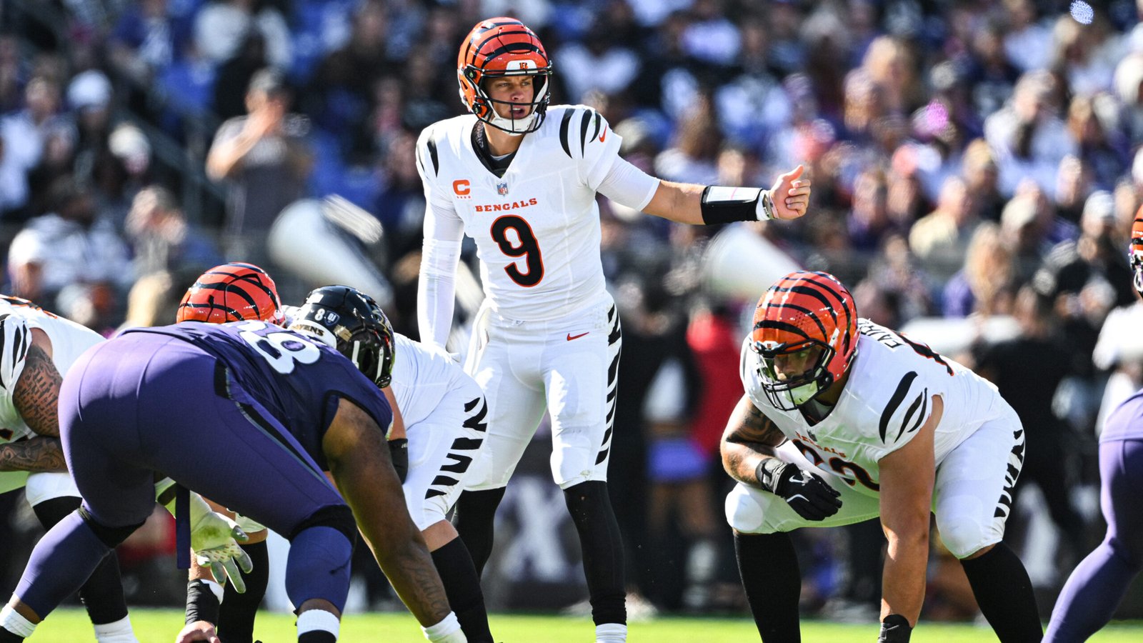 Joe Burrow stands at the line of scrimmage for Cincinnati against Baltimore.