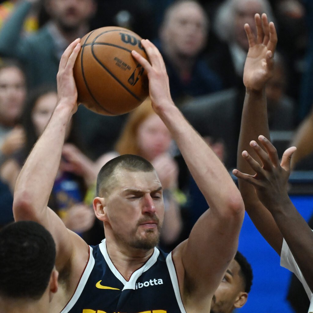 Nikola Jokić holds the ball above his head during overtime against New Orleans on October 24, 2026.