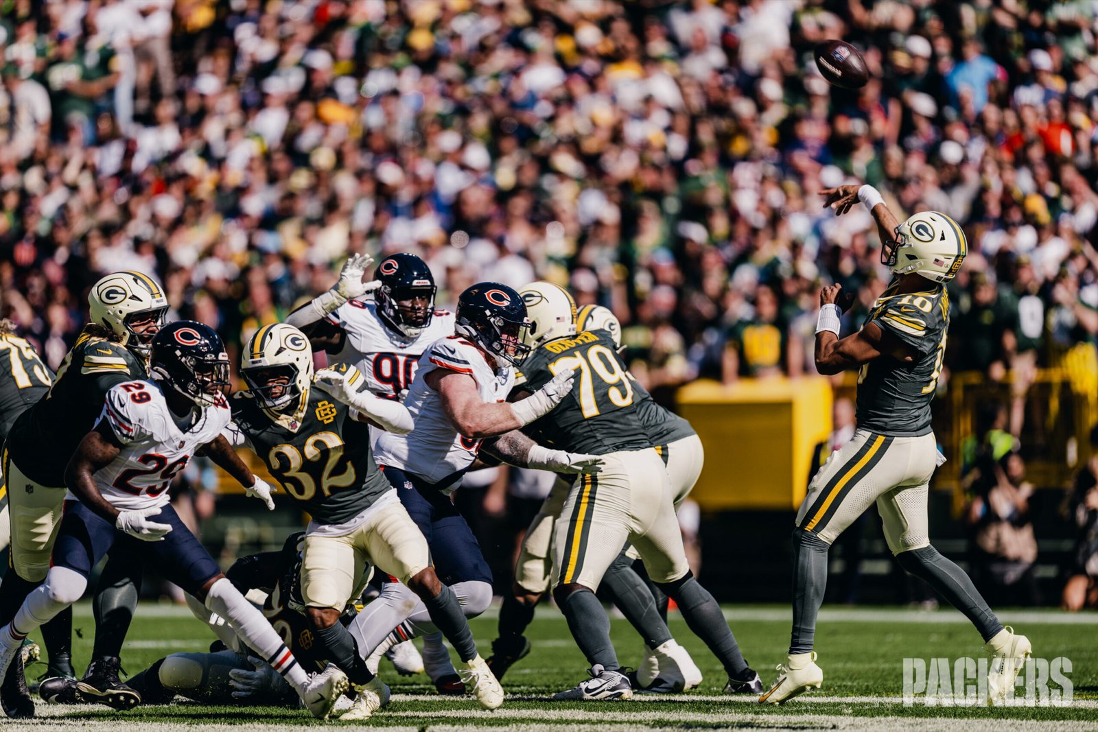Jordan Love throws a pass behind Packers blockers at Lambeau Field.